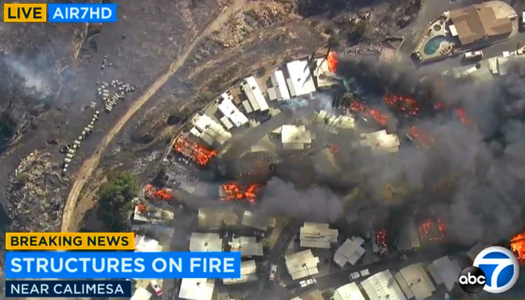 KABC-TV VIA AP
                                This photo from video provided by KABC-TV shows Strong, gusting winds push flames through the Villa Calimesa mobile home park in Calimesa, Calif., southeast of San Bernardino. Multiple residences have burned in the fire, that started shortly afternoon.
