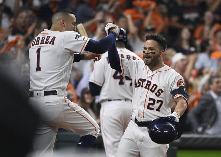 ASSOCIATED PRESS
                                Houston Astros second baseman Jose Altuve (27) celebrates his solo home run against the Tampa Bay Rays with Carlos Correa (1) during the eighth inning of Game 5 of the American League Division Series in Houston Thursday.