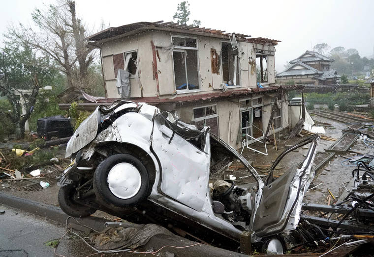 KATSUYA MIYAGAWA/KYODO NEWS VIA AP
                                Destroyed house and vehicle are seen following a strong wind in Ichihara, Chiba, near Tokyo. Tokyo and surrounding areas braced for a powerful typhoon forecast as the worst in six decades, with streets and trains stations unusually quiet Saturday as rain poured over the city.