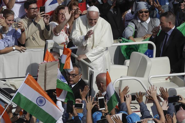 ASSOCIATED PRESS
                                Pope Francis is driven through the crowd in St. Peter’s Square at the Vatican today.