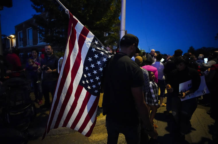 ASSOCIATED PRESS
                                A large crowd of protesters, including a man carrying an upside-down American flag, gather outside the house where Atatiana Jefferson was shot Saturday and killed by police, during a community vigil for Jefferson on Sunday, Oct. 13, 2019, in Fort Worth, Texas.