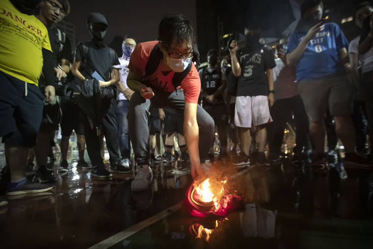 ASSOCIATED PRESS
                                Demonstrators set a Lebron James jersey on fire during a rally at the Southorn Playground in Hong Kong today.