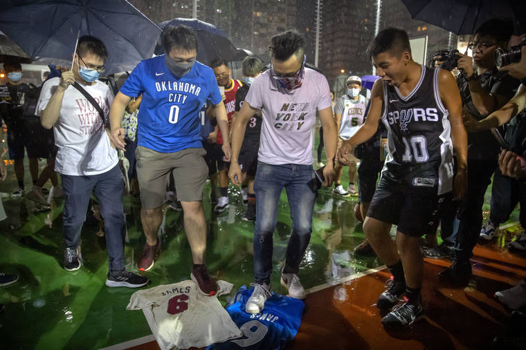 ASSOCIATED PRESS
                                Demonstrators stamp on Lebron James jerseys during a rally at the Southorn Playground in Hong Kong today. Protesters in Hong Kong have thrown basketballs at a photo of LeBron James and chanted their anger about comments the Los Angeles Lakers star made about free speech during a rally in support of NBA commissioner Adam Silver and Houston Rockets general manager Daryl Morey, whose tweet in support of the Hong Kong protests touched off a firestorm of controversy in China.