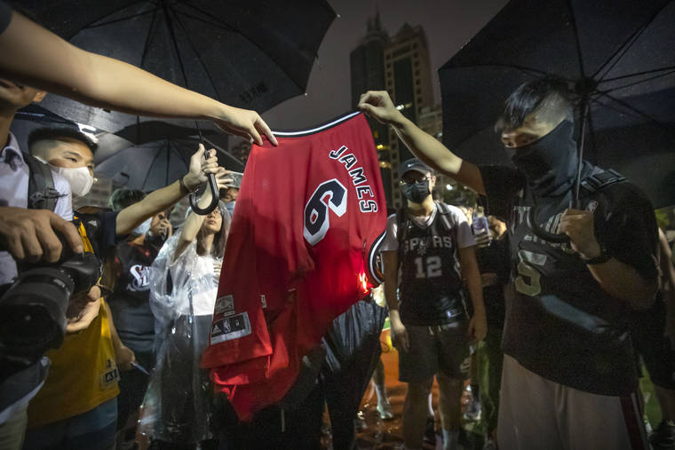 ASSOCIATED PRESS
                                Demonstrators set a Lebron James jersey on fire during a rally at the Southorn Playground in Hong Kong, today.
