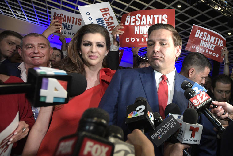 ASSOCIATED PRESS / 2018
                                Florida Govenor-elect Ron DeSantis, right, answers questions from reporters, with his wife Casey, after being declared the winner of the Florida gubernatorial race at an election party, in Orlando, Fla. Standing behind Casey DeSantis is Lev Parnas. Parnas and his associate Igor Furman are facing federal charges in connection to efforts by President Donald Trump’s lawyer, Rudy Giuliani, to launch a Ukrainian corruption investigation against Joe Biden and his son, Hunter.
