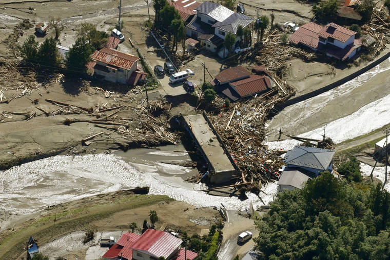 KYODO NEWS VIA ASSOCIATED PRESS
                                Driftwood is piled around a bridge after Typhoon Hagibis hits the town in Marumori, Miyagi prefecture, northern Japan, Wednesday. The typhoon hit Japan’s main island on Saturday with strong winds and historic rainfall that caused more than 200 rivers to overflow, leaving thousands of homes flooded, damaged or without power.