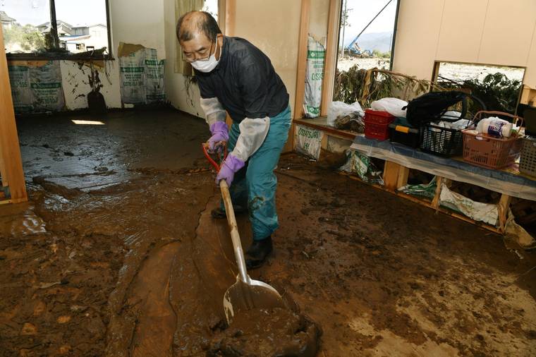 KYODO NEWS VIA ASSOCIATED PRESS
                                A man cleans a house devastated by Typhoon Hagibis, in Nagano, central Japan, Wednesday.
