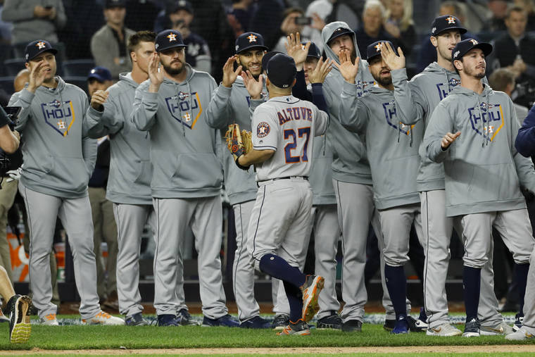 ASSOCIATED PRESS
                                Houston Astros second baseman Jose Altuve celebrates with teammates after their 4-1 win against the New York Yankees in Game 3 of baseball’s American League Championship Series Tuesday in New York.