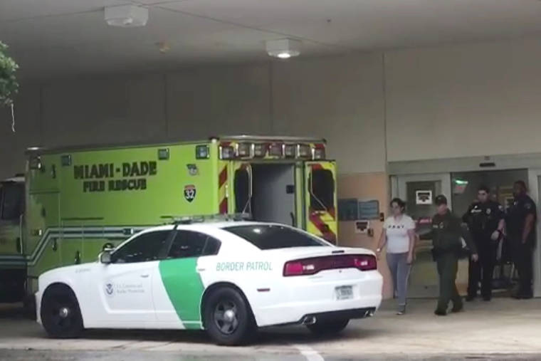 FLORIDA IMMIGRANT COALITION VIA ASSOCIATED PRESS
                                A border patrol agents escorts a woman to a patrol car Sunday at Aventura Hospital in Aventura, Fla. The woman had been detained by border patrol agents, when she fell ill. The agent took her to the hospital emergency room for treatment.