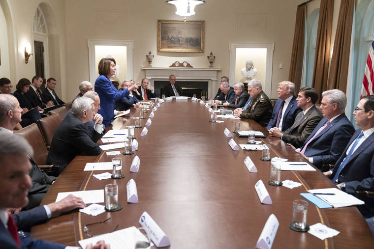 ASSOCIATED PRESS
                                In this photo released by the White House, President Donald Trump, center right, meets with House Speaker Nancy Pelosi, standing left, Congressional leadership and others, Wednesday in the Cabinet Room of the White House in Washington.