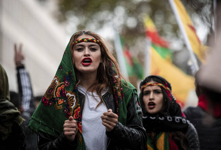FABIAN STRAUCH/DPA VIA AP
                                Participants of a Kurdish demonstration against the Turkish military offensive in Northern Syria demonstrate in Cologne, Germant.
