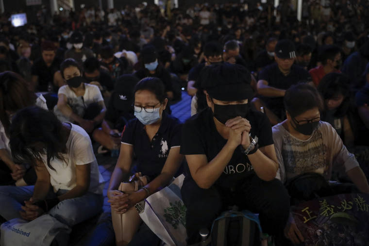ASSOCIATED PRESS
                                Protesters attend a prayer rally at Edinburgh Place in Hong Kong on Saturday.