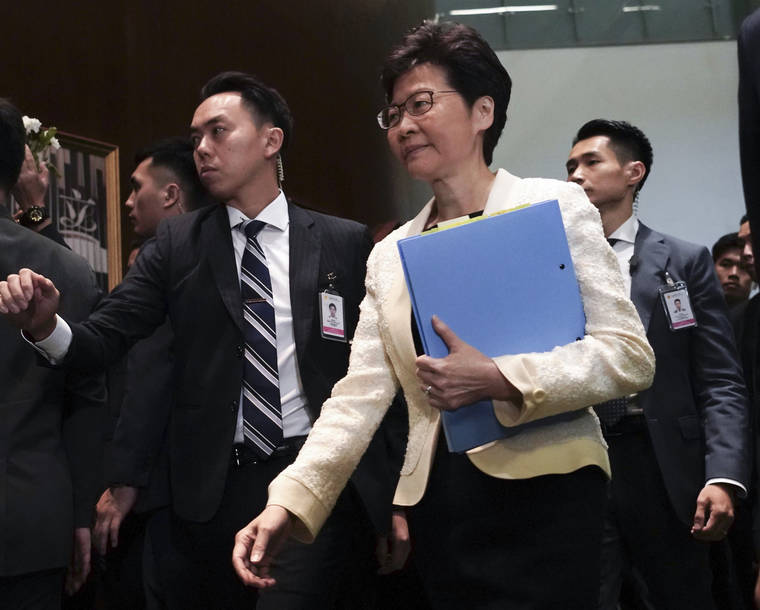 ASSOCIATED PRESS
                                Hong Kong Chief Executive Carrie Lam, center, arrives at chamber of the Legislative Council in Hong Kong.