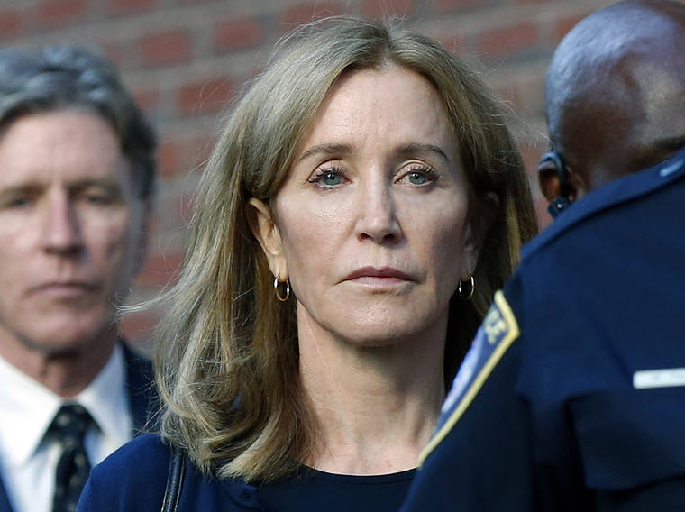 ASSOCIATED PRESS / Sept. 13
                                Actress Felicity Huffman leaves federal court in Boston with her brother Moore Huffman Jr., left, after she was sentenced in a nationwide college admissions bribery scandal. Huffman was sentenced to 14 days in federal prison in Dublin, Calif., but was released early this morning after serving 10 days.