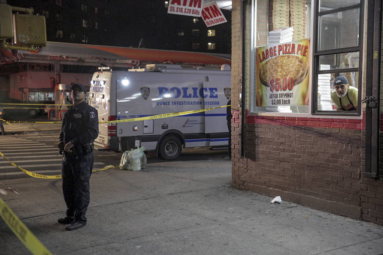 ASSOCIATED PRESS
                                A New York Police officer stands watch at the scene of a shooting where two police officers were injured and one person was shot in the Brownsville neighborhood of the Brooklyn borough of New York.