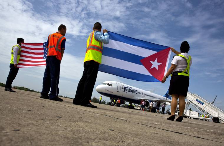 ASSOCIATED PRESS / 2016
                                Airport workers receive JetBlue flight 387, the first commercial flight between the U.S. and Cuba in more than a half century, holding a United States, and a Cuban national flag, on the airport tarmac in Santa Clara, Cuba. The Trump administration is banning U.S. flights to all Cuban cities except Havana starting in December 2019.