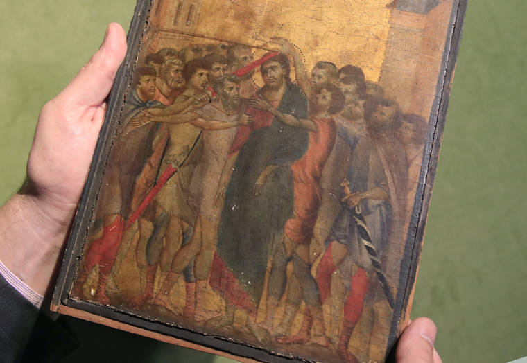 ASSOCIATED PRESS
                                Art expert Stephane Pinta points to a 13th-century painting by Italian master Cimabue in Paris on Sept. 24.