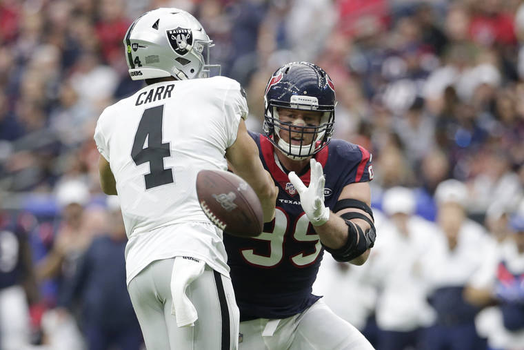 ASSOCIATED PRESS
                                Houston Texans defensive end J.J. Watt (99) blocks a pass by Oakland Raiders quarterback Derek Carr (4) during the first half of an NFL football game today in Houston.