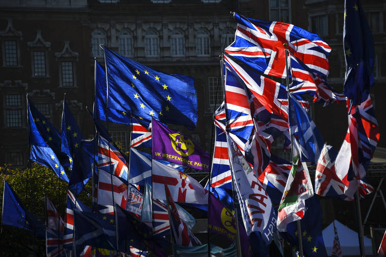 ASSOCIATED PRESS
                                European Union and British flags flap outside the Houses of Parliament in London, Monday. European Council president Donald Tusk says the bloc has agreed to grant Britain a new Brexit delay to Jan. 31 next year.