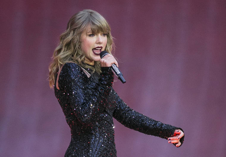 ASSOCIATED PRESS
                                Taylor Swift performs on stage in concert at Wembley Stadium in London in 2018. A 27-year-old Austin, Texas, man has pleaded guilty to stalking and sending threatening letters and emails to pop star Taylor Swift’s former record label. Federal prosecutors in Nashville, Tennessee, said in a news release the letters to Big Machine Label Group began in January 2018 with Eric Swarbrick asking the CEO to introduce him to Swift.