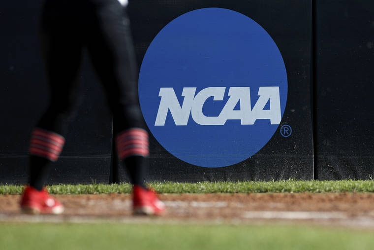 ASSOCIATED PRESS
                                An athlete stood near an NCAA logo, April 19, during a softball game in Beaumont, Texas. The NCAA Board of Governors has taken the first step toward allowing athletes to cash in on their fame.