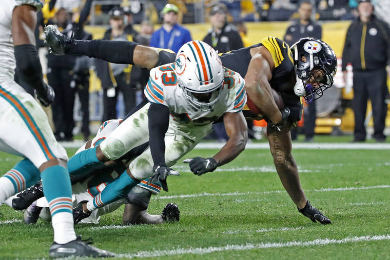 ASSOCIATED PRESS
                                Pittsburgh Steelers running back James Conner, right, dove for the end zone for a touchdown with Miami Dolphins cornerback Jomal Wiltz defending during the second half of a game in Pittsburgh, Monday.