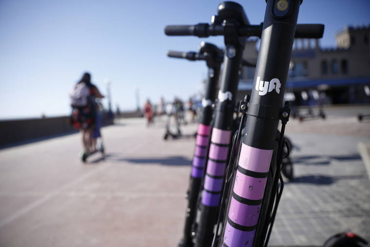 ASSOCIATED PRESS / MAY 28
                                Lyft scooters are seen along Mission Beach boardwalk in San Diego. Lyft, Inc. reports financial earns on Oct. 30.