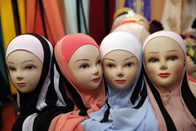 ASSOCIATED PRESS
                                Mannequins with veils are on display inside an exhibition hall at the France Muslim Annual Fair in Le Bourget, north of Paris.