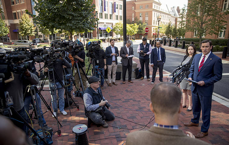 Attorney General for the Eastern District of Virginia G. Zachary Terwilliger, right, accompanied by Assistant United States Attorney Danya Atiyeh, second from right, announces the arrest of Henry Kyle Frese, a Defense Intelligence Agency official charged with leaking classified information to two journalists, including one he was dating, during a news conference outside the federal courthouse in Alexandria, Va., Wednesday, Oct. 9, 2019. (AP Photo/Andrew Harnik)