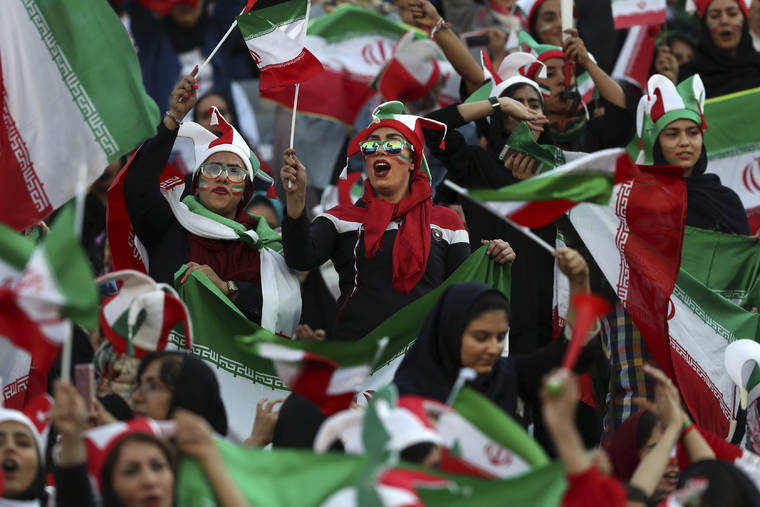 ASSOCIATED PRESS
                                Iranian women cheer during a soccer match between their national team and Cambodia in the 2022 World Cup qualifier at the Azadi (Freedom) Stadium in Tehran, Iran. Iranian women were freely allowed into the stadium for the first time in decades. The decision follows the death of a young woman who set herself on fire after hearing she could face prison time for sneaking into an Iranian soccer match disguised as a man.