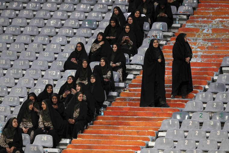 ASSOCIATED PRESS
                                Female police officers work at the Azadi (Freedom) Stadium during a soccer match between Iran and Cambodia in the 2022 World Cup qualifier in Tehran, Iran. Iranian women were freely allowed into the stadium for the first time in decades. The decision follows the death of a young woman who set herself on fire after hearing she could face prison time for sneaking into an Iranian soccer match disguised as a man.