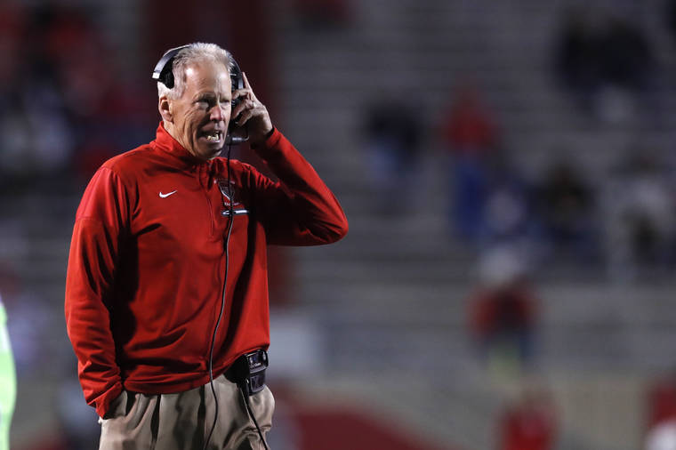 ASSOCIATED PRESS
                                New Mexico coach Bob Davie speaks through his headphones during the first half against Colorado State on Oct. 11.