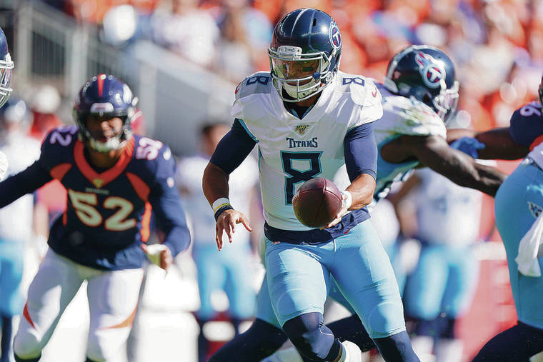 ASSOCIATED PRESS
                                Tennessee Titans quarterback Marcus Mariota handed the ball off during the first half of Sunday’s game against the Denver Broncos. Mariota will be the backup to Ryan Tannehill this week.