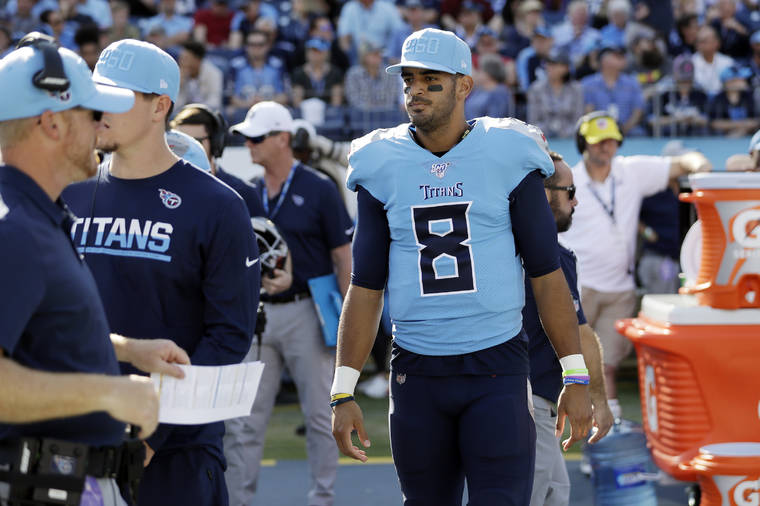 ASSOCIATED PRESS
                                Tennessee Titans quarterback Marcus Mariota watches from the sideline in the first half.