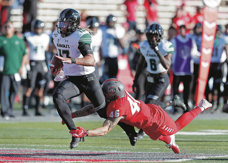 ASSOCIATED PRESS
                                Hawaii quarterback Cole McDonald was tackled by New Mexico linebacker Brandon Shook during Saturday’s game in Albuquerque, N.M.