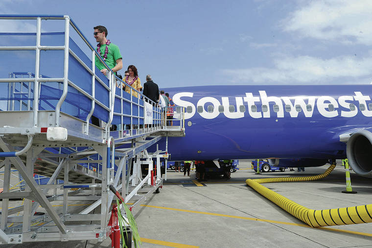 BRUCE ASATO / MARCH 17
                                Southwest Airlines will start daily service to San Diego from Kahului and Honolulu in April. Passengers exit from the airline’s inaugural flight from Oakland, Calif., to Honolulu.