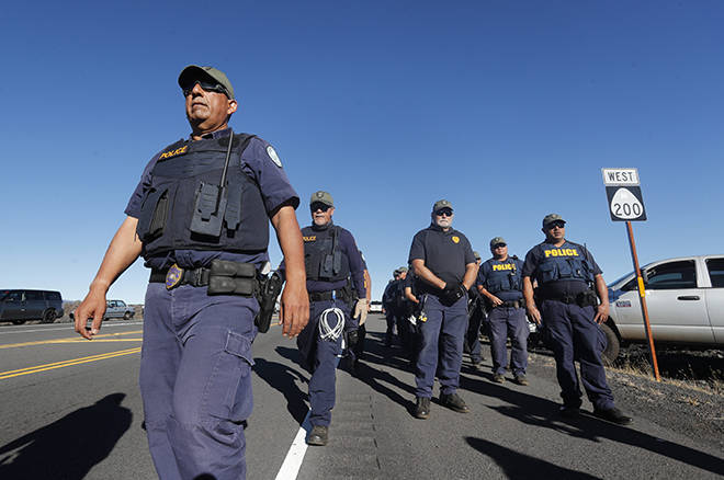 CINDY ELLEN RUSSELL / July 15
                                Hawaii Police Department officers arrive at Daniel K. Inouye Highway on Mauna Kea in July. The total cost of law enforcement to the state and counties is more than $7.7 million even before one key state agency has disclosed its costs.
