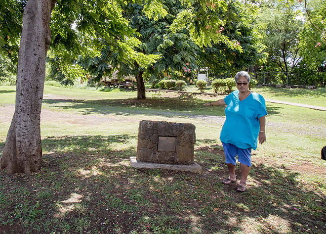 KAT WADE / Special to the Honolulu Star-Advertiser
                                Evelyn Ahlo, executive director of Hawaii’s Plantation Village, shows off the large grass area where a temporary pop-up homeless shelter will soon be constructed at the Waipahu Cultural Center last week.