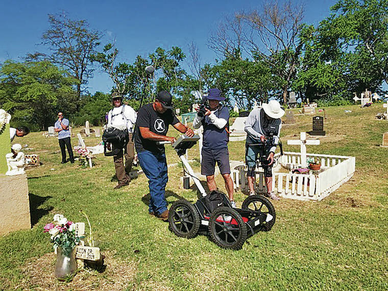 COURTESY STEPHANIE CASTILLO
                                Researcher Kawika Wilson, center, was documented by a film crew Sunday as he worked at the potential Hanapepe Massacre grave site in Hanapepe, Kauai.
