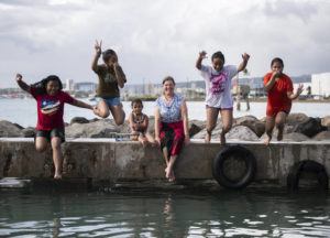 CINDY ELLEN RUSSELL / OCT. 11
                                Athline Clark, monument superintendent for the National Oceanic and Atmospheric Administration, sits at the boat ramp near the University of Hawaii Marine Center Sand Island facility, where she paddles. Joining her, from left to right, are Dellia Johnson, 11, Rosedina James, 11, Nerisha Batlog, 4, Tera Johnson, 10, and Ciara Batlok, 10.