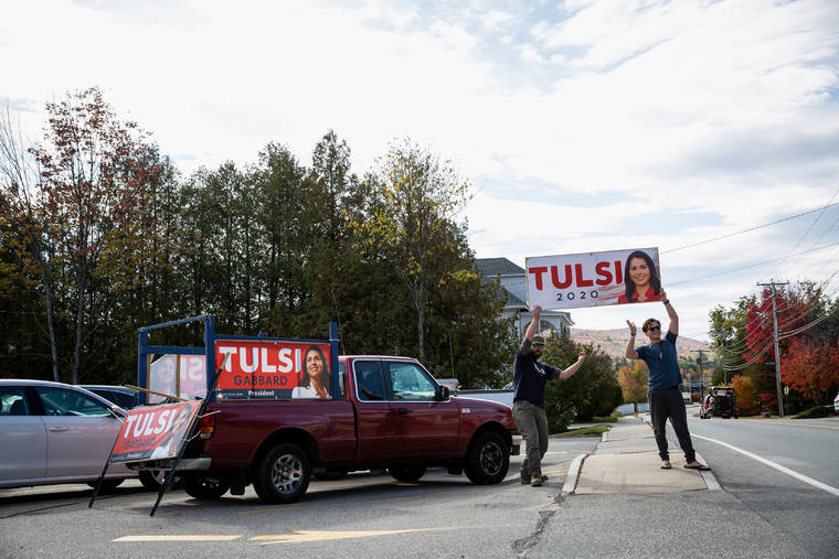 ELIZABETH FRANTZ/THE NEW YORK TIMES
                                Volunteers hold up a sign before the start of a town hall campaign event with Democratic presidential candidate Rep. Tulsi Gabbard (D-Hawaii) at Northland Restaurant and Dairy Bar in Berlin, N.H., Oct. 11, 2019. As Gabbard injects chaos into the 2020 Democratic primary by accusing her own party of “rigging” the election, an array of alt-right internet stars, white nationalists and Russians have praised her.