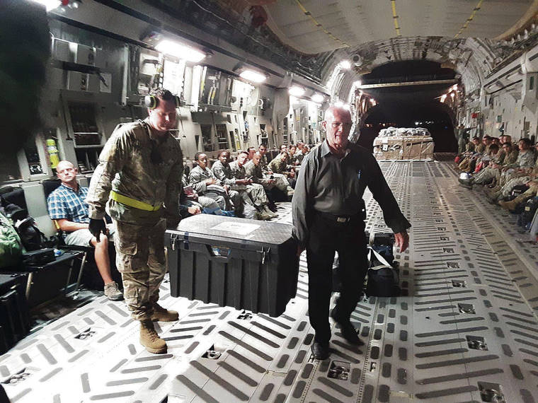 COURTESY GENE CASTAGNETTI
                                Former Punchbowl cemetery Director Gene Castagnetti, right, assisted Sept. 13 with the offloading of the remains of 81 South Vietnamese soldiers in California following an Air Force C-17 flight from Hawaii.