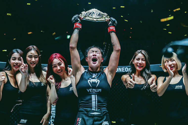 COURTESY ONE CHAMPIONSHIP
                                Mililani’s Angela Lee held her atomweight belt high overhead after getting Xiong Jing Nan to submit in their championship bout Sunday in Tokyo.