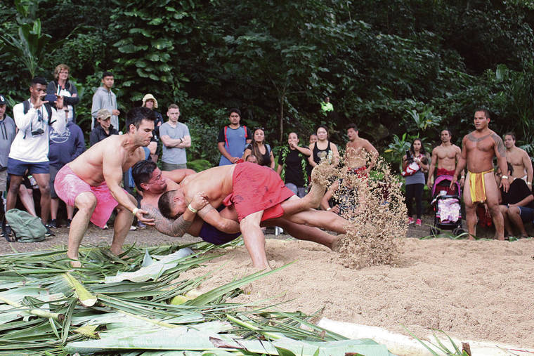 COURTESY WAIMEA VALLEY
                                Participants compete in hakoko (wrestling), one of the Heiva Tu‘aro I Vaihi contests.