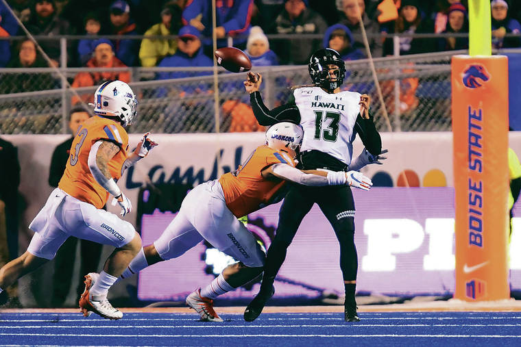 STEVEN ERLER / SPECIAL TO THE STAR-ADVERTISER
                                Boise State linebacker Curtis Weaver hit Hawaii quarterback Cole McDonald to force a fumble during the second quarter of the Broncos’ victory over the Rainbow Warriors on Saturday at Albertsons Stadium in Boise, Idaho.