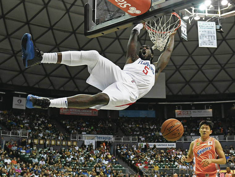 BRUCE ASATO / BASATO@STARADVERTISER.COM
                                Los Angeles Clippers power forward Montrezl Harrell threw down a breakaway dunk during the first quarter of Sunday’s exhibition game at the Stan Sheriff Center.