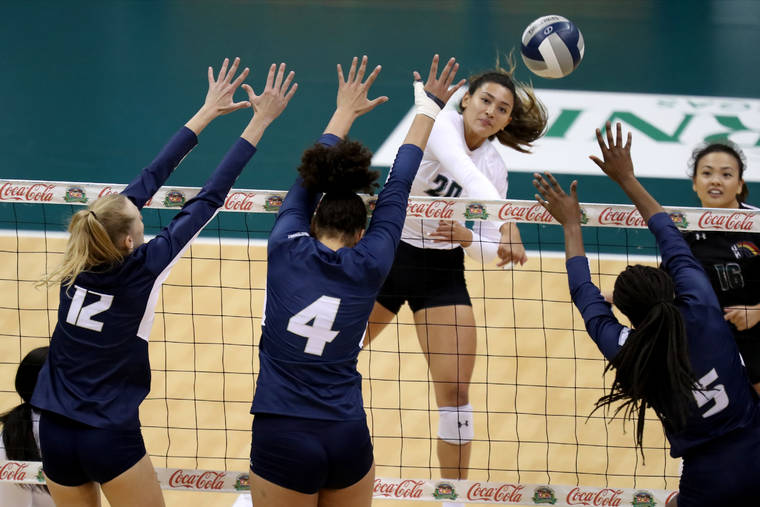 ANDREW LEE / SPECIAL TO THE STAR-ADVERTISER.
                                Hawaii’s McKenna Ross hits over UC Davis’ Leonie Strehl (12), Josephine Ough (4) and Mahalia White (5).