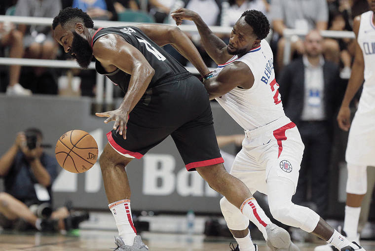 JAMM AQUINO / JAQUINO@STARADVERTISER.COM
                                Houston Rockets guard James Harden, left, worked against Los Angeles Clippers guard Patrick Beverley during Thursday’s game at the Stan Sheriff Center.