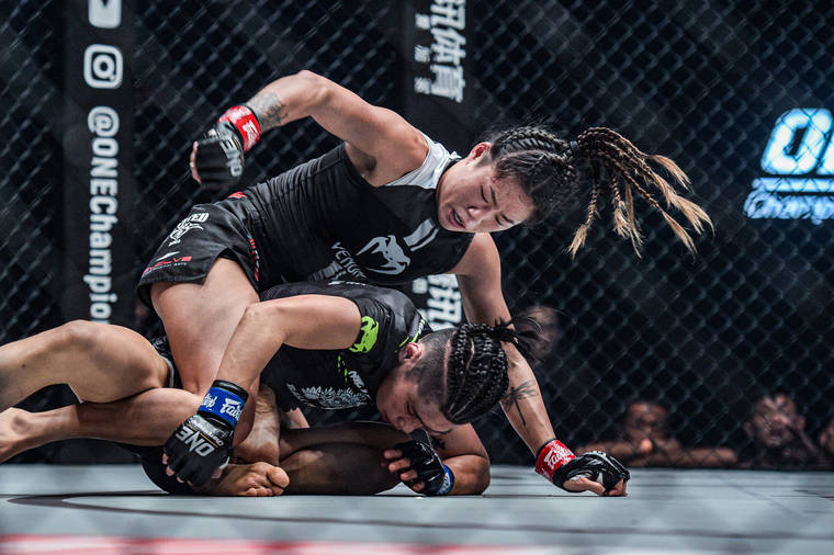 COURTESY ONE CHAMPIONSHIP
                                Angela Lee gets on top of Xiong Jing Nan during their bout in Tokyo.