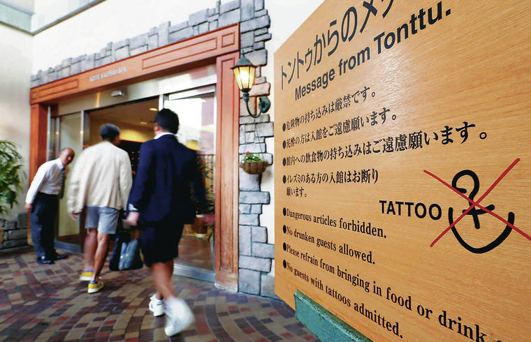 JAPAN NEWS-YOMIURI
                                A sign at Kobe Sauna & Spa in Chuo Ward, Kobe, above, states a ban on people with tattoos.